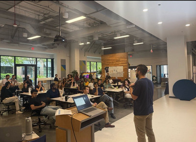 20-20 students sitting in The Hatchery listening intently to a presenter