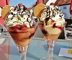 Two ice cream sundaes on a table