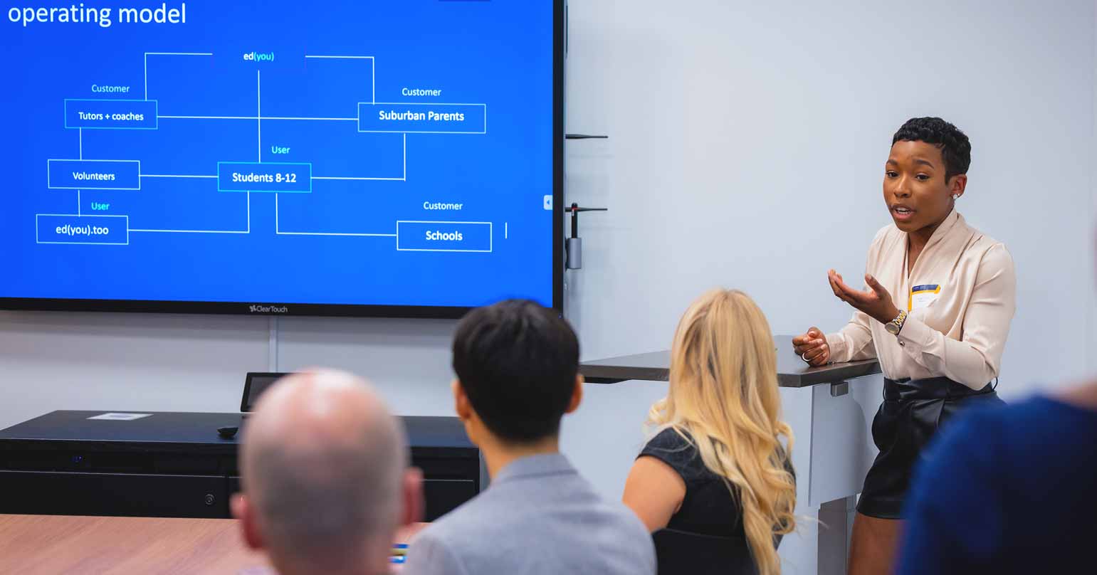 Woman instructing a classroom