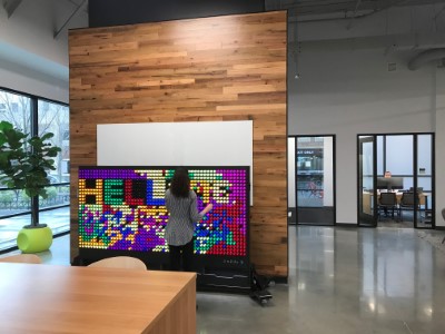 student placing pegs on a giant pegboard