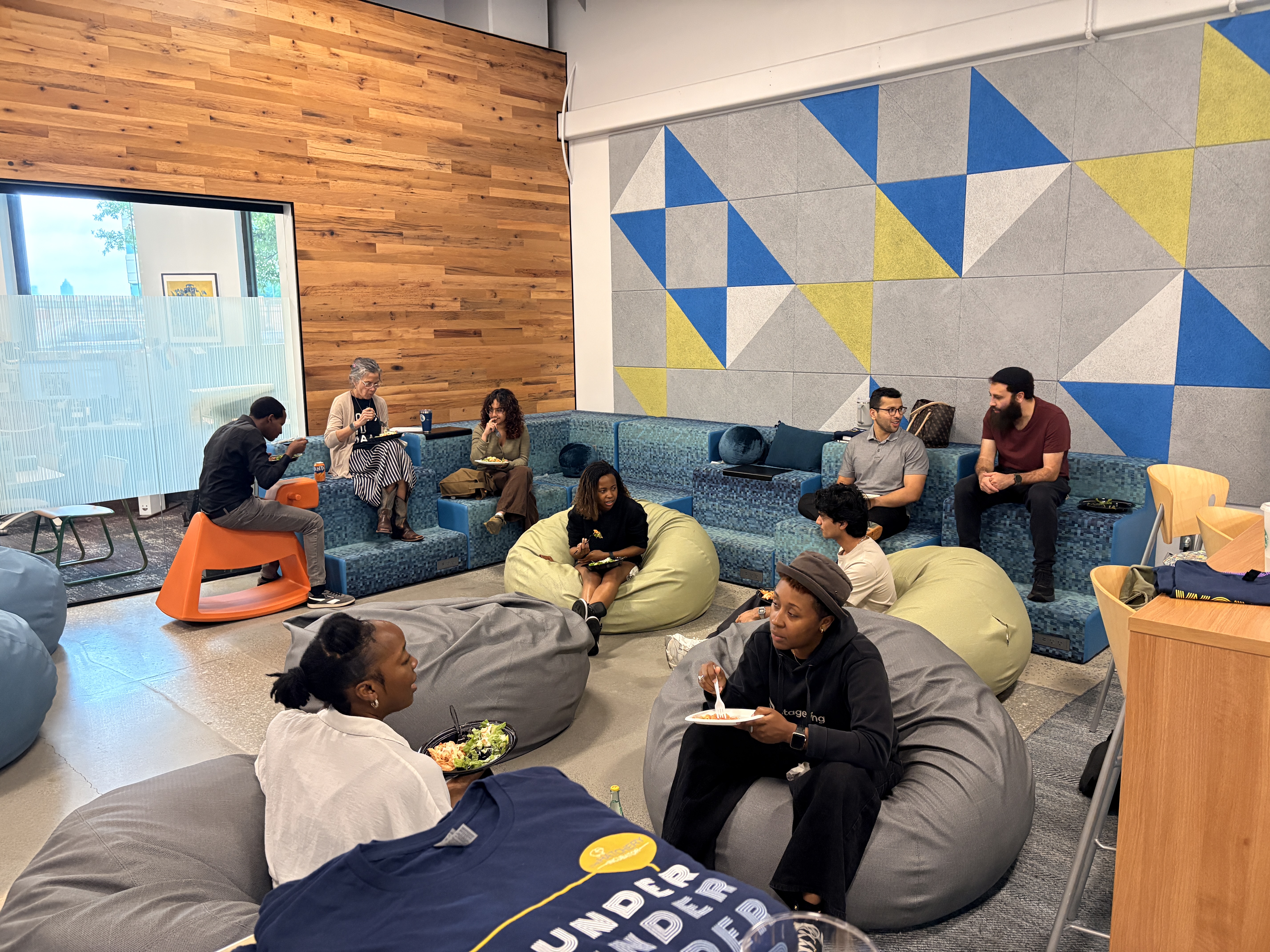 Student founders at The Hatchery sit on beanbags and a large blue sofa.