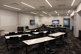 white classroom with black roller chairs
